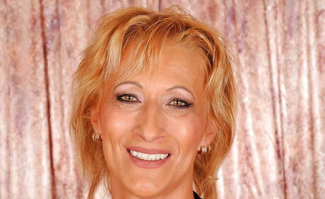 Sultry blonde granny Yda in fancy skirt exhibiting small tits and spreading her legs 